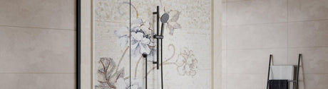 Matte-black single slide rail with round handheld set against a light mosaic floral wall.