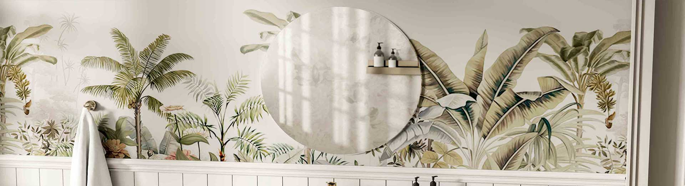 Round mirror on tropical-themed wallpaper in a bright bathroom
