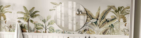 Round mirror on tropical-themed wallpaper in a bright bathroom