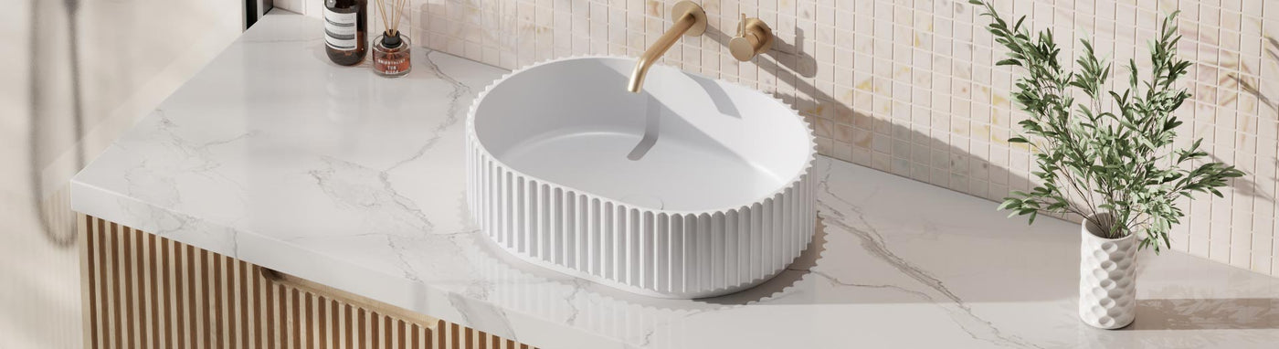 Oval solid surface basin on marble vanity top