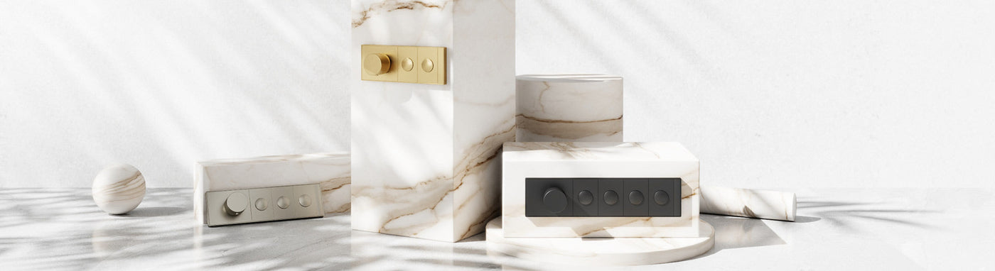 Thermostatic shower control panels with temperature dial and push-button diverters in brushed gold, matte black and nickel.