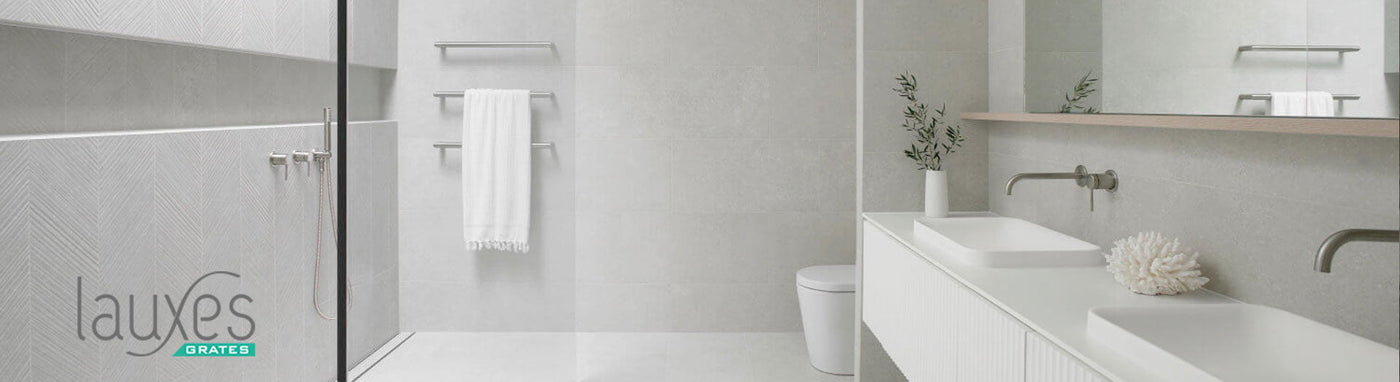 Lauxes bathroom with modern drainage and tile insert grates.