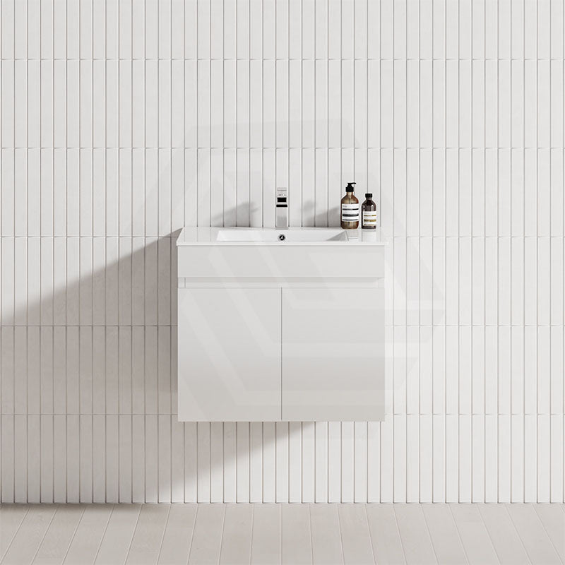A modern white bathroom featuring a 600mm wall-hung 2-door floating vanity