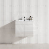 A modern white bathroom featuring a 600mm wall-hung 2-door floating vanity