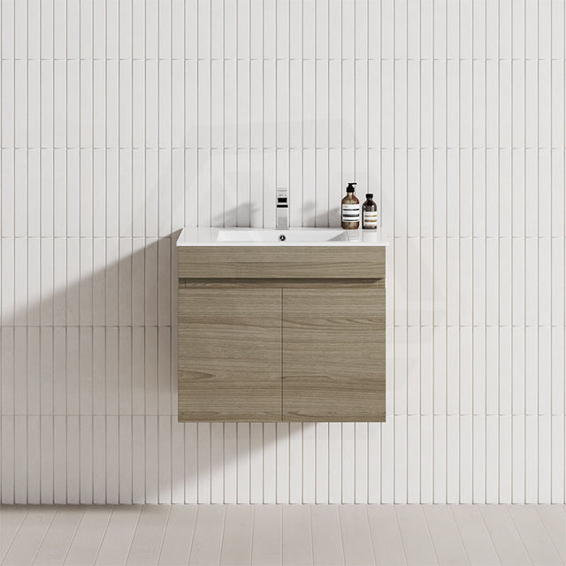 A modern bathroom featuring a floating vanity in Maison Oak and a clean white tile wall