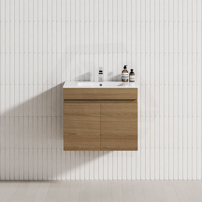 A modern bathroom featuring a Tasmanian oak wall-hung vanity cabinet with a single bowl sink