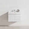 A wall-hung matt white bathroom vanity with a single bowl sink, showcasing a modern floating design