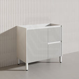 White cabinet with ribbed design on a plain background