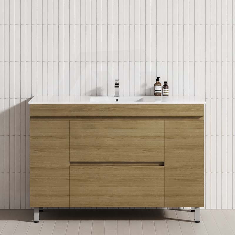 Modern bathroom vanity in prime oak with a white tiled wall, featuring 2 drawers and 2 doors for storage