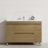 Modern bathroom vanity in prime oak with a white tiled wall, featuring 2 drawers and 2 doors for storage