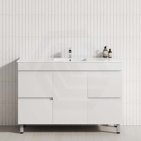 Stylish bathroom vanity against a white tiled wall, showcasing a 4-drawer, 1-door design in matt white